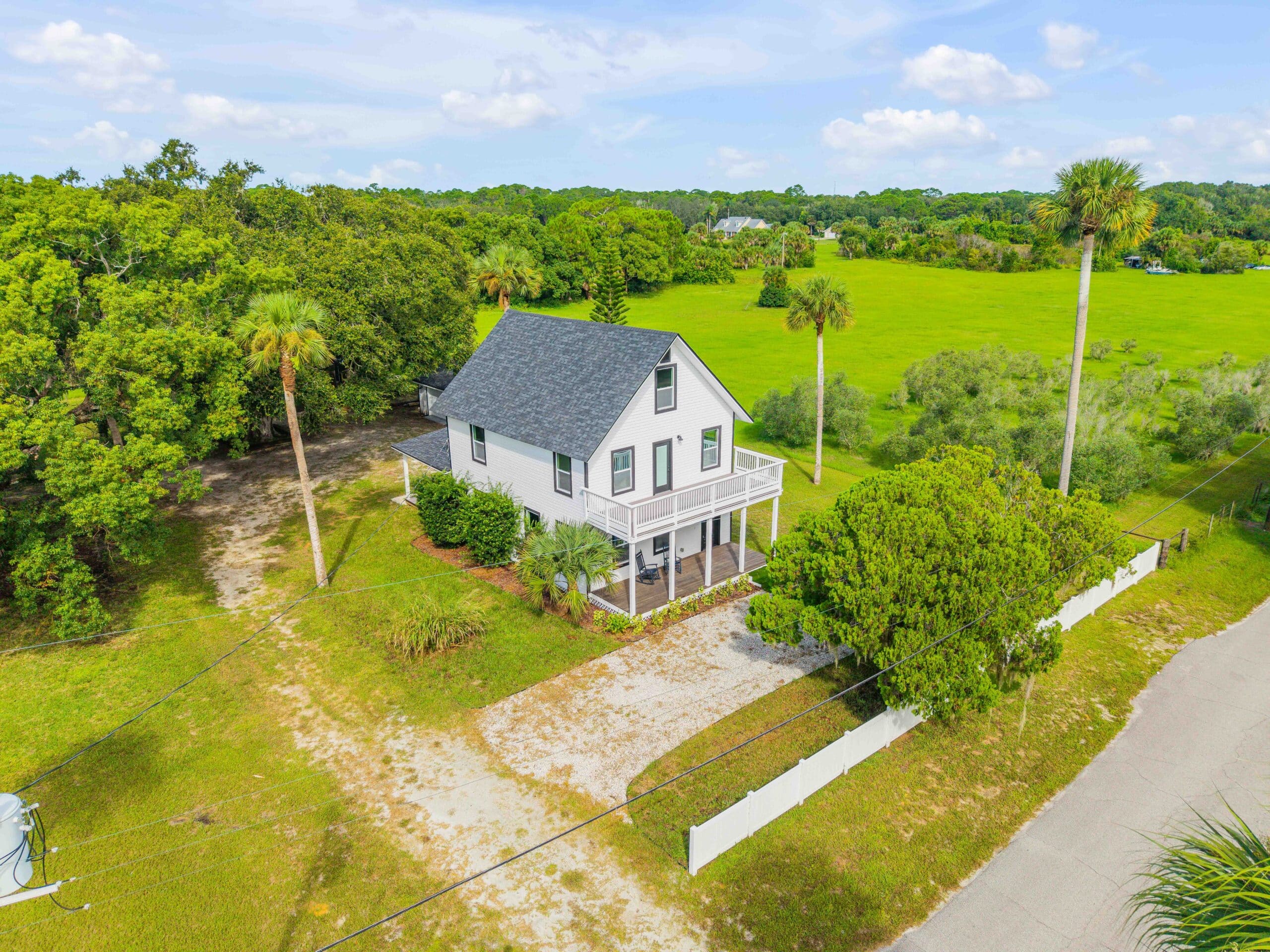 Hayley Vezza | Local Living Realty Group: White coastal home with wrap-around porch