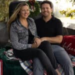 Hayley Vezza and partner in vintage truck with Christmas decor