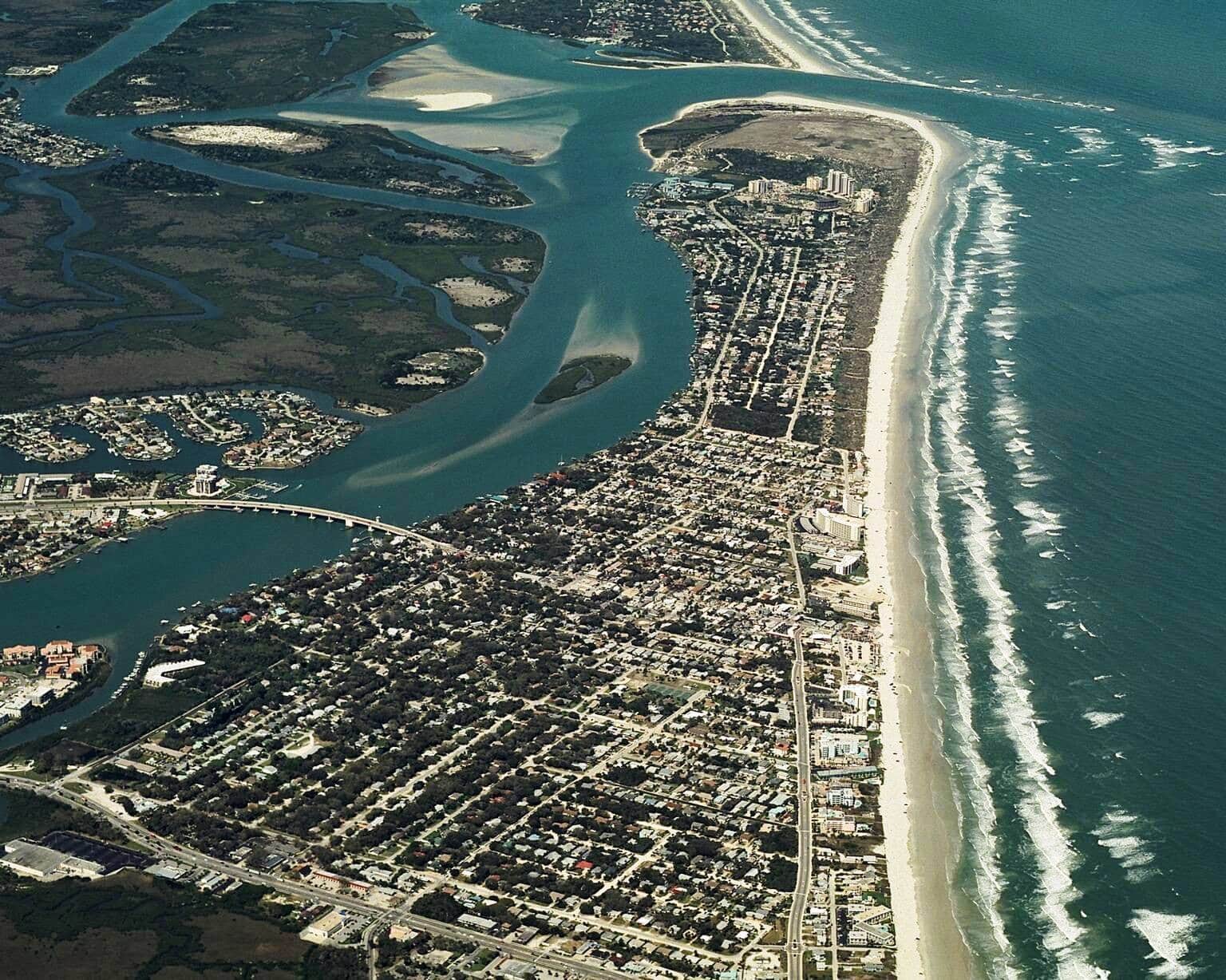 Aerial view of coastal Florida real estate with oceanfront homes and waterways.