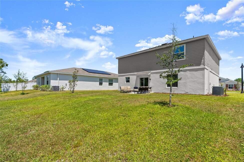 Backyard view of a modern home at 2516 Hoptree Ln, Edgewater, FL 32141