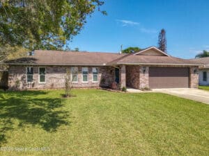 Front exterior of 2813 Sabal Palm Dr, Edgewater, FL 32141, a brick ranch home.
