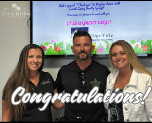 Three people celebrating in front of a screen with "Congratulations!" text