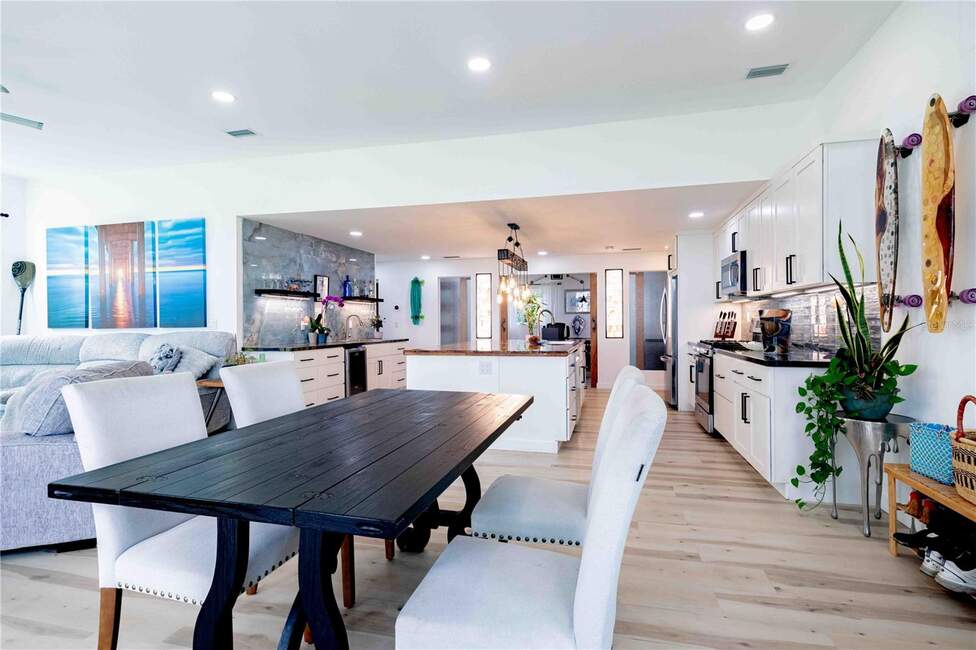 Open-plan living and dining area with modern kitchen at 500 S Riverside Dr, Edgewater, FL.